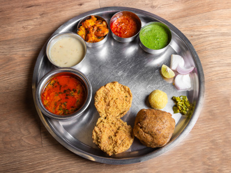 Dal Bafla Thali (Dal Kadhi Bafla (2) Aloo Ki Sabji Laddu (1 Pc) Green Chutney Garlic Chutney Onion) (Serves 1)