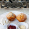 2 Homemade Scones Served With Jam, Butter And Fresh Cream